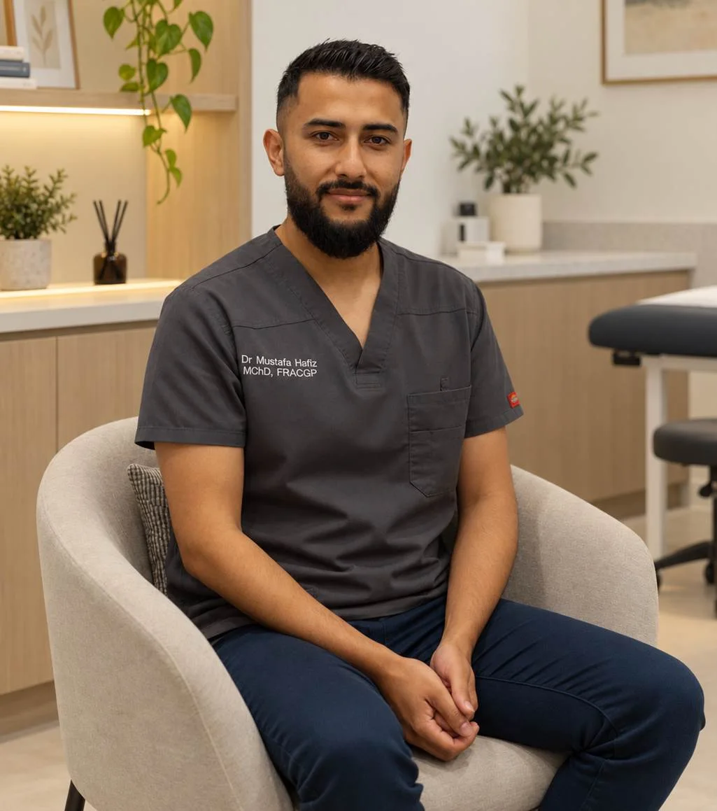 Dr Mustafa Hafiz in dark scrubs, seated in a consulting room